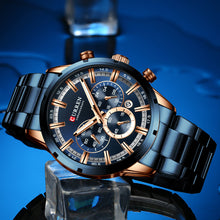 Load image into Gallery viewer, Luxury watch with blue and gold design on a reflective blue surface